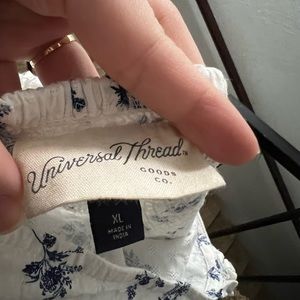 White dress with blue flowers, stretchy straps.